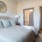 a bedroom with a bed and a mirror