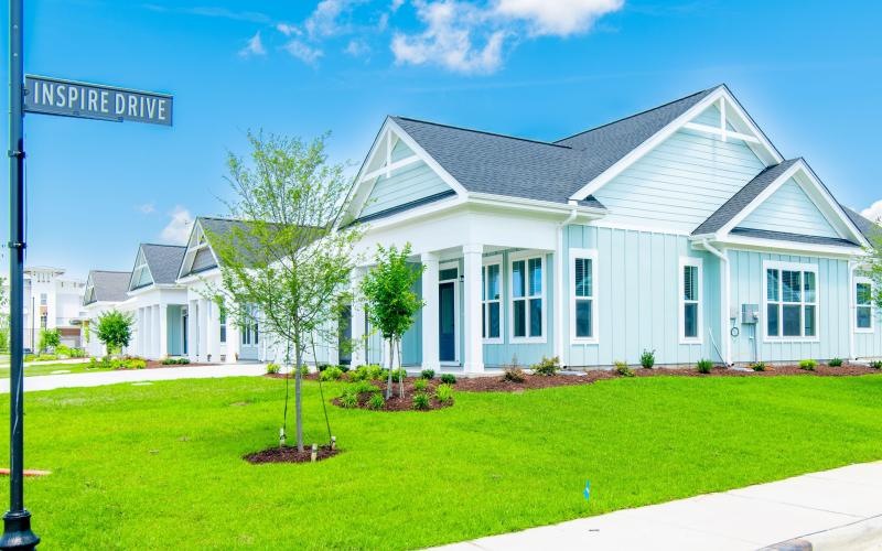 a white house with a green lawn