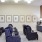 a theater room with a tv, couch and chairs