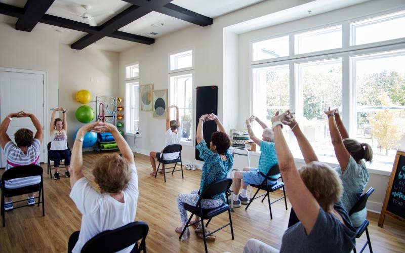 a group of people in a room exercising