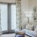 a living room with a white couch and a white table