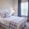a bedroom with a bed and desk