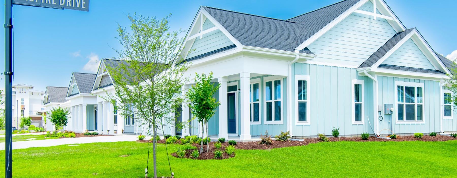a white house with a green lawn