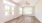 a room with a wood floor and a ceiling fan