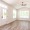 a room with a wood floor and a ceiling fan