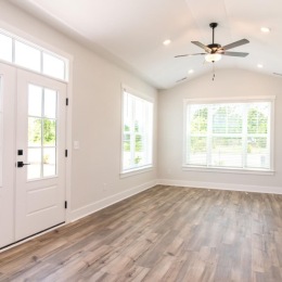 a room with a wood floor and a ceiling fan