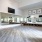 a large room with a wood floor and workout equipment